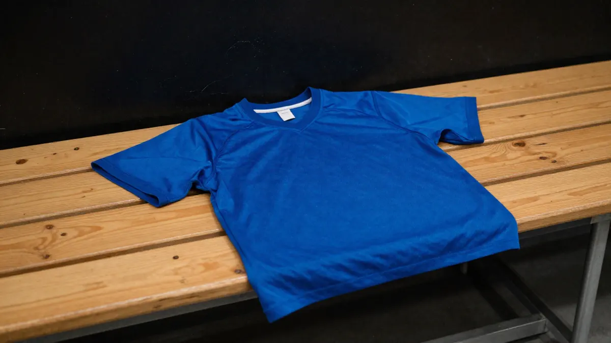 FC Barcelona shirt from 2017 laid flat on a bench, showing crew collar and fabric to check before buying